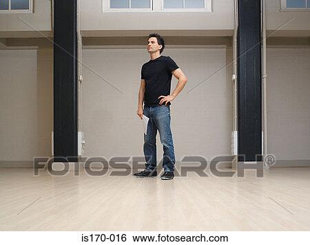 Stock Photograph - Man in an empty office space. Fotosearch