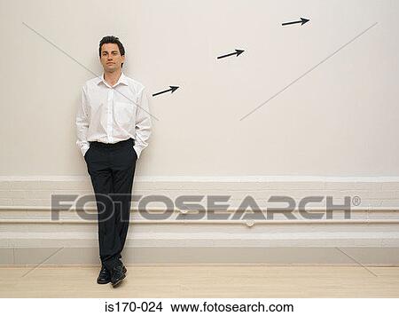 Man leaning on wall by arrow signs View Large Photo Image Picture - Man leaning on wall by arrow signs. Fotosearch