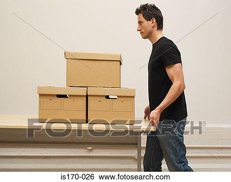 Man moving a desk and boxes View Large Photo Image Stock Photograph - Man moving a desk and boxes. Fotosearch