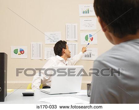 Man pointing to chart on the wall View Large Photo Image Stock Image - Man pointing to chart on the wall. Fotosearch