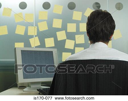 Man with adhesive notes in his office View Large Photo Image Stock Photo - Man with adhesive notes in his office. Fotosearch