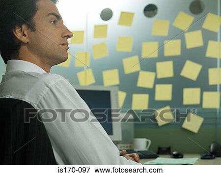 Man with adhesive notes in his office View Large Photo Image Stock Photo - Man with adhesive notes in his office. Fotosearch