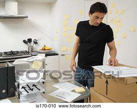 Man with office in the kitchen View Large Photo Image Stock Image - Man with office in the kitchen. Fotosearch