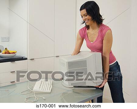 Woman moving computer monitor View Large Photo Image Stock Image - Woman moving computer monitor. Fotosearch