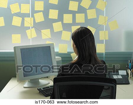Woman with adhesive notes in her office View Large Photo Image Stock Image - Woman with adhesive notes in her office. Fotosearch