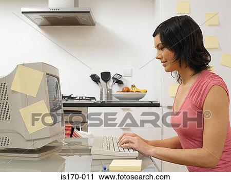 Stock Image - Woman working in the kitchen. Fotosearch