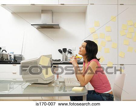 Stock Photo - Woman working in the kitchen. Fotosearch