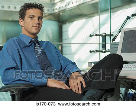 Young businessman in his office View Large Photo Image Stock Image - Young businessman in his office. Fotosearch