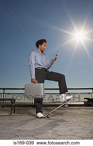 Businessman on a skateboard View Large Photo Image Stock Photo - Businessman on a skateboard. Fotosearch