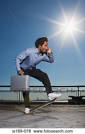 Stock Photo - Businessman on a skateboard. Fotosearch