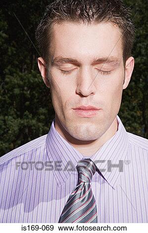 Stock Photo - Businessman with his eyes closed. Fotosearch