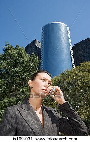 Businesswoman using a cellular telephone View Large Photo Image Stock Image - Businesswoman using a cellular telephone. Fotosearch