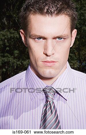 Hostile looking businessman View Large Photo Image Stock Image - Hostile looking businessman. Fotosearch