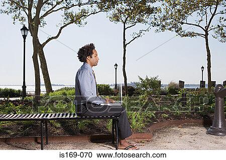 Man telecommuting in a park View Large Photo Image Stock Image - Man telecommuting in a park. Fotosearch