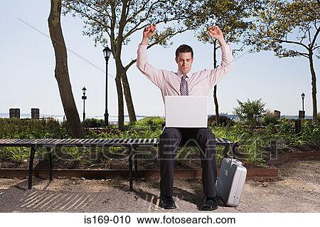 Triumphant businessman in a park View Large Photo Image Stock Image - Triumphant businessman in a park. Fotosearch