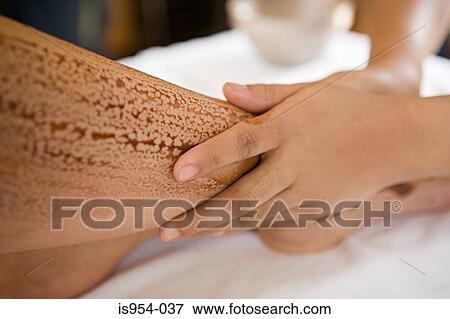 Applying oil to womans leg View Large Photo Image Stock Photo - Applying oil to womans leg. Fotosearch