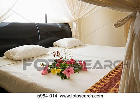 Picture - Flowers on bed. Fotosearch