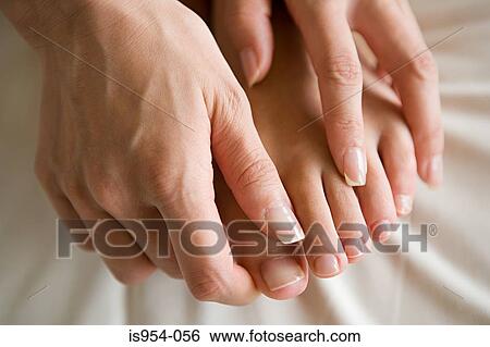 Stock Photograph - Hands massaging feet. Fotosearch