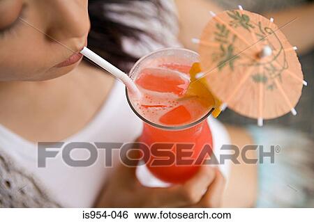 Stock Photograph - Woman drinking cocktail. Fotosearch
