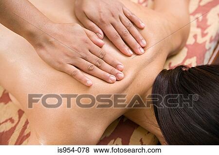 Woman having back massaged View Large Photo Image Stock Photo - Woman having back massaged. Fotosearch