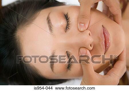 Picture - Woman having face massaged. Fotosearch