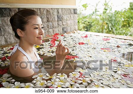 Woman in pool with flower petals View Large Photo Image Stock Photo - Woman in pool with flower petals. Fotosearch