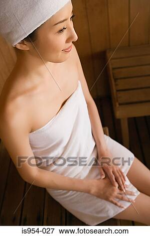 Woman sitting on wooden bench View Large Photo Image Stock Photo - Woman sitting on wooden bench. Fotosearch