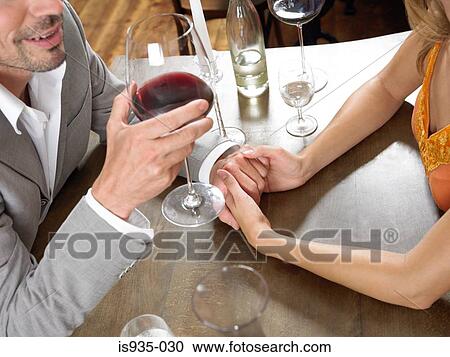 Couple holding hands at table View Large Photo Image Stock Image - Couple holding hands at table . Fotosearch