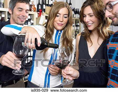Stock Photo - Group of friends at wine tasting. Fotosearch