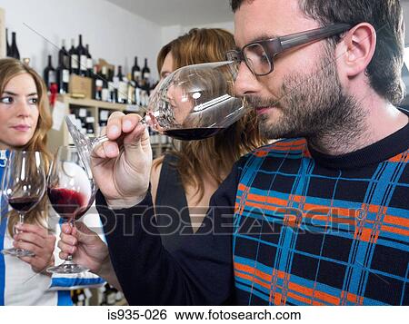 Stock Photograph - Group of friends at wine tasting. Fotosearch