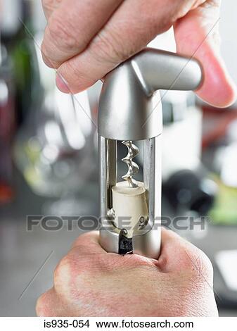 Hand using corkscrew View Large Photo Image Picture - Hand using corkscrew. Fotosearch