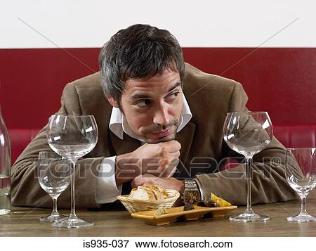 Man at table with bread and olives View Large Photo Image Stock Photo - Man at table with bread and olives. Fotosearch