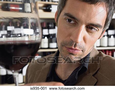 Man holding glass of red wine View Large Photo Image Stock Image - Man holding glass of red wine. Fotosearch