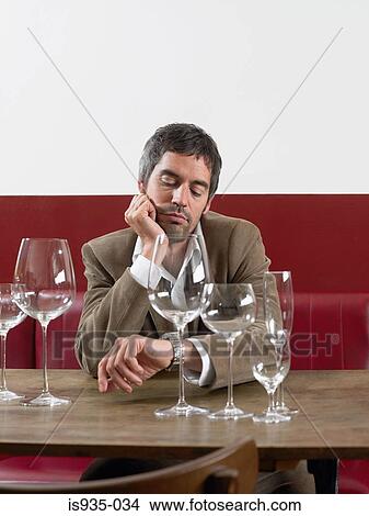 Picture - Man looking at watch. Fotosearch