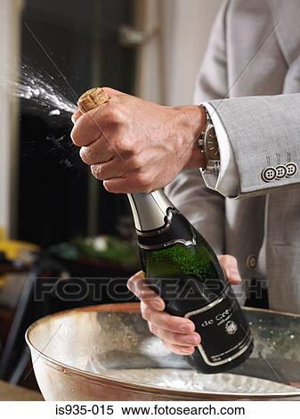 Stock Photography - Man opening champagne bottle. Fotosearch