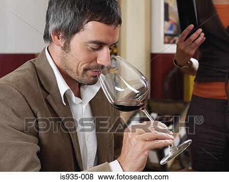 Stock Photo - Man smelling red wine. Fotosearch