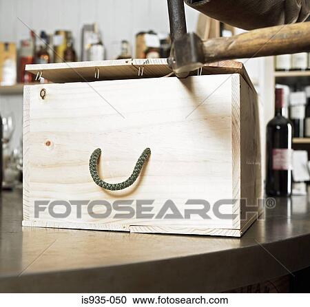Stock Image - Opening case of wine. Fotosearch