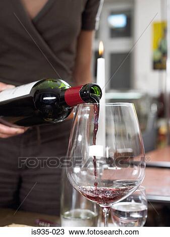 Pouring red wine into glass View Large Photo Image Stock Image - Pouring red wine into glass. Fotosearch