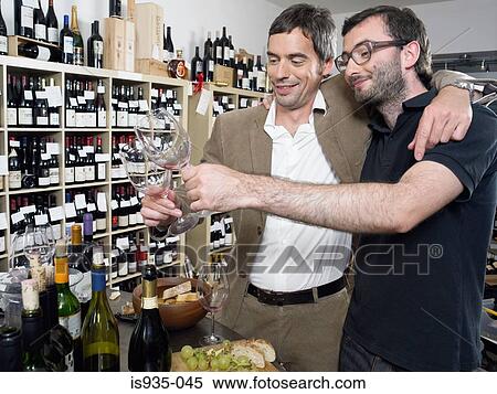 Stock Photography - Two men at wine tasting. Fotosearch