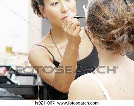 Beautician applying mascara View Large Photo Image Stock Photo - Beautician applying mascara. Fotosearch