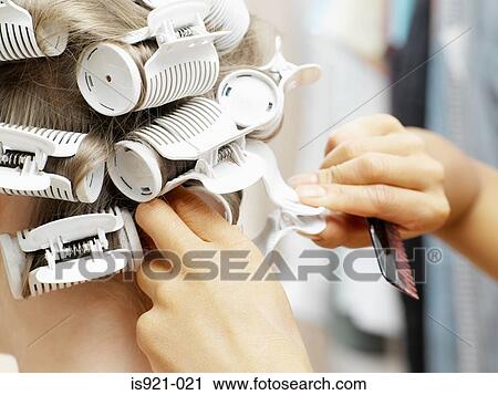 Hairdresser putting in curlers View Large Photo Image Stock Image - Hairdresser putting in curlers. Fotosearch