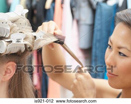 Hairdresser working on model's hair View Large Photo Image Stock Image - Hairdresser working on model's hair. Fotosearch