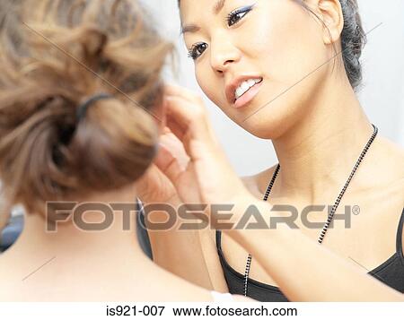 Stock Photo - Make-up artist working on model. Fotosearch