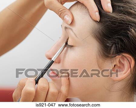 Model having eyeshadow applied View Large Photo Image Stock Photo - Model having eyeshadow applied. Fotosearch