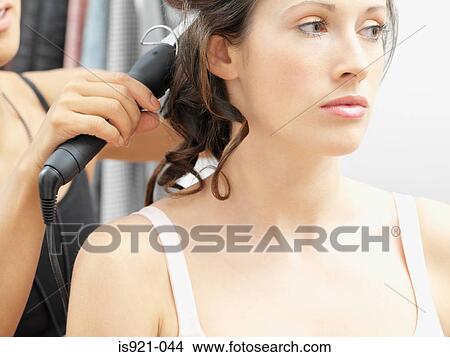 Model having her hair curled View Large Photo Image Picture - Model having her hair curled. Fotosearch