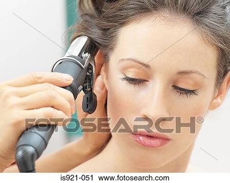 Model having her hair curled View Large Photo Image Stock Image - Model having her hair curled. Fotosearch