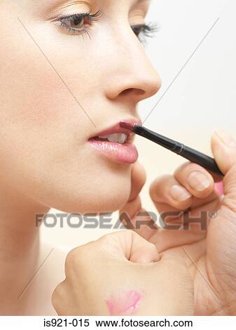 Stock Photography - Model having lipgloss applied. Fotosearch