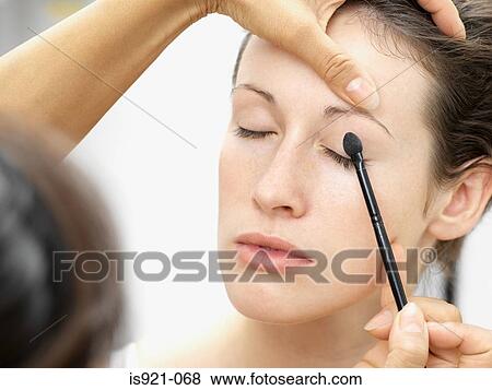 Woman having eye shadow applied View Large Photo Image Stock Photo - Woman having eye shadow applied. Fotosearch