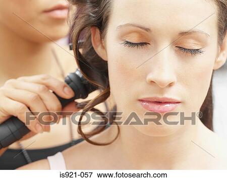 Woman having her hair curled View Large Photo Image Stock Photo - Woman having her hair curled. Fotosearch