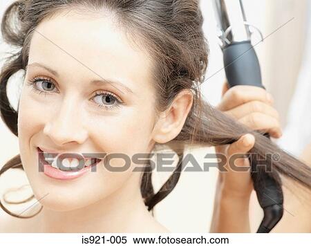 Woman having her hair curled View Large Photo Image Stock Photography - Woman having her hair curled. Fotosearch
